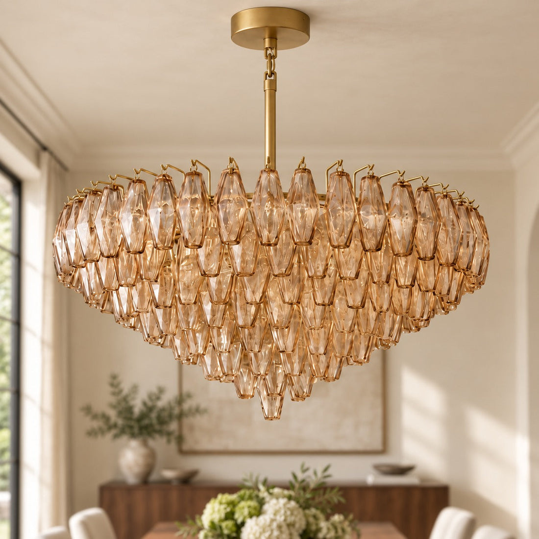 Large brass and amber glass chandelier above a dining table